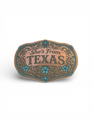 Belt buckle with 'She's From Texas' text on a white background