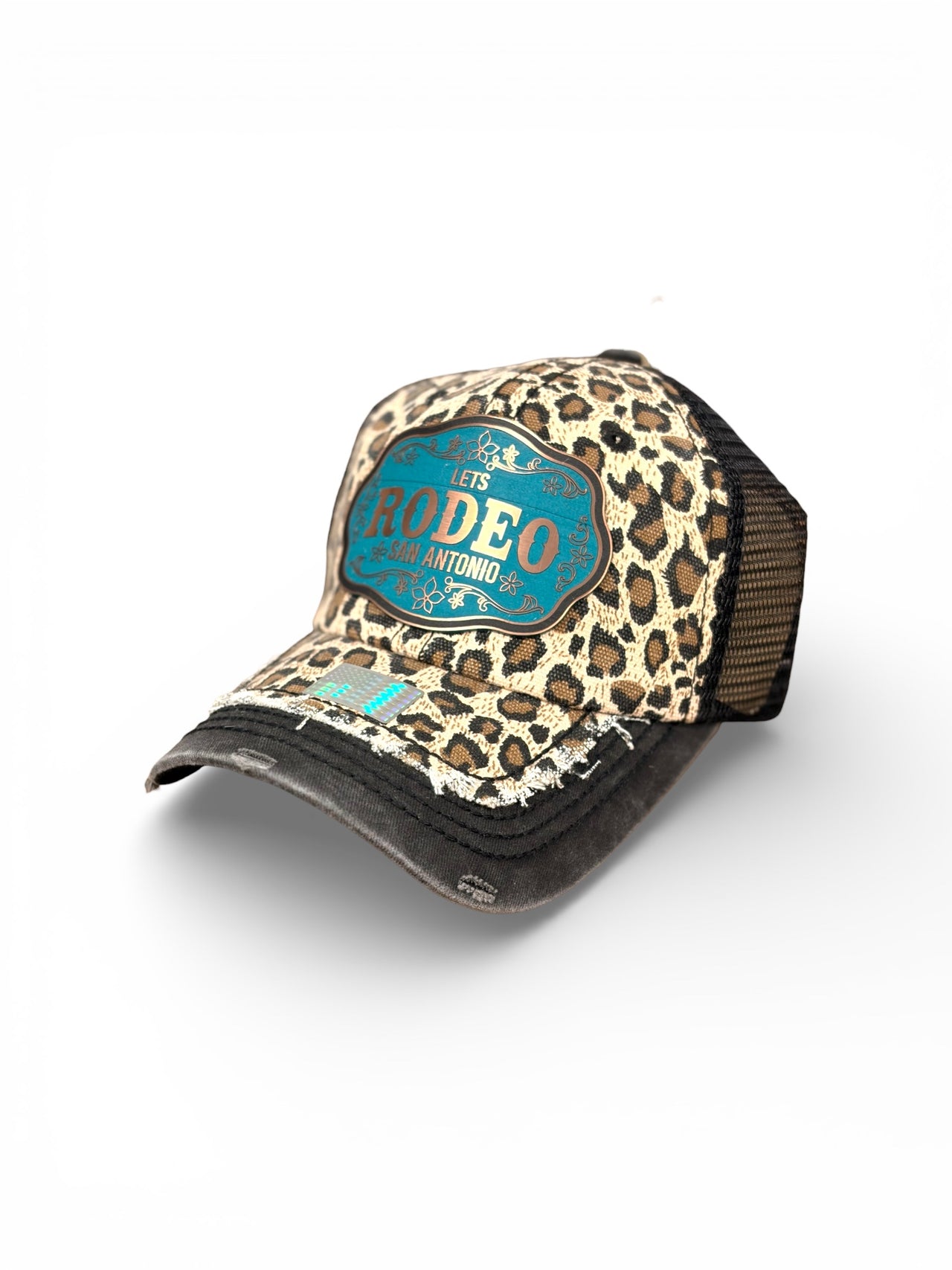 Leopard print cap with teal label on a white background